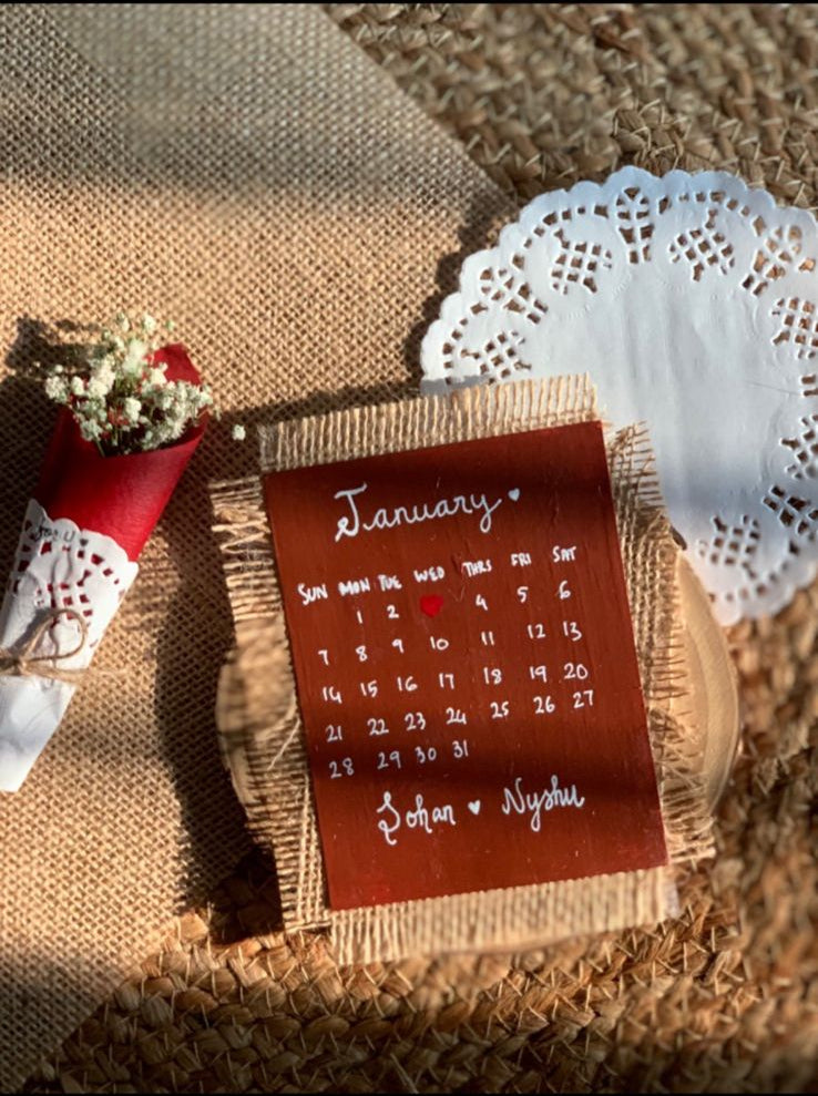 Handcrafted personalized desk calendar with wooden base and decorative design on textured surface