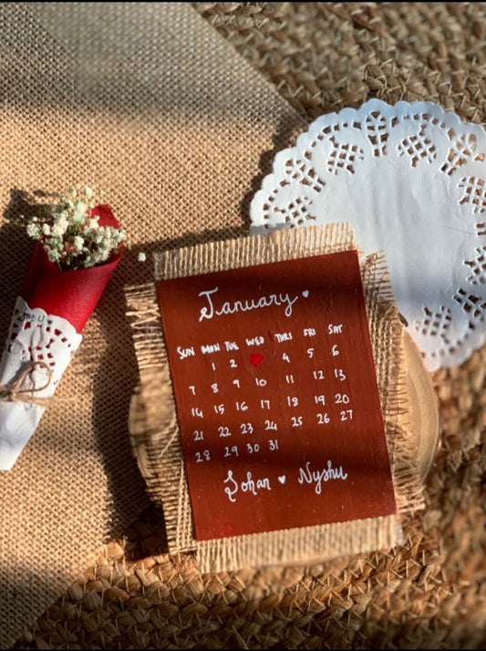 Handcrafted personalized desk calendar with wooden base and decorative design on textured surface