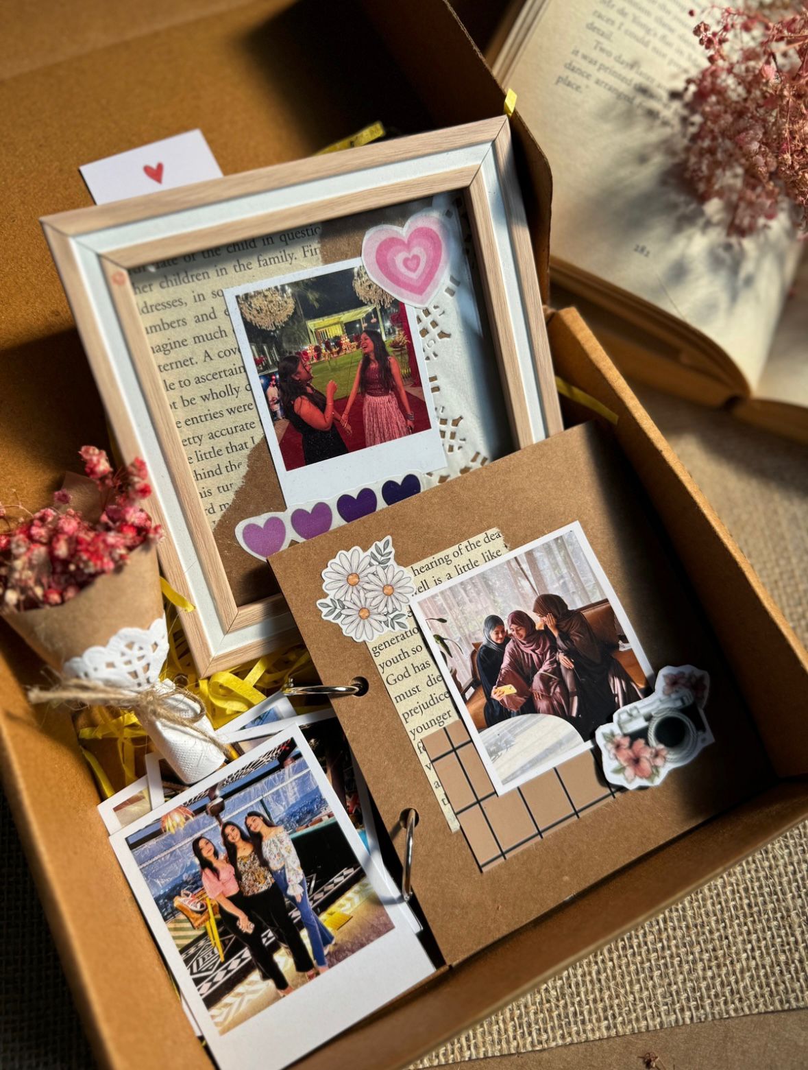 Cute picture frame combo set with Polaroid photos, flower bouquet, and ring book on wooden table