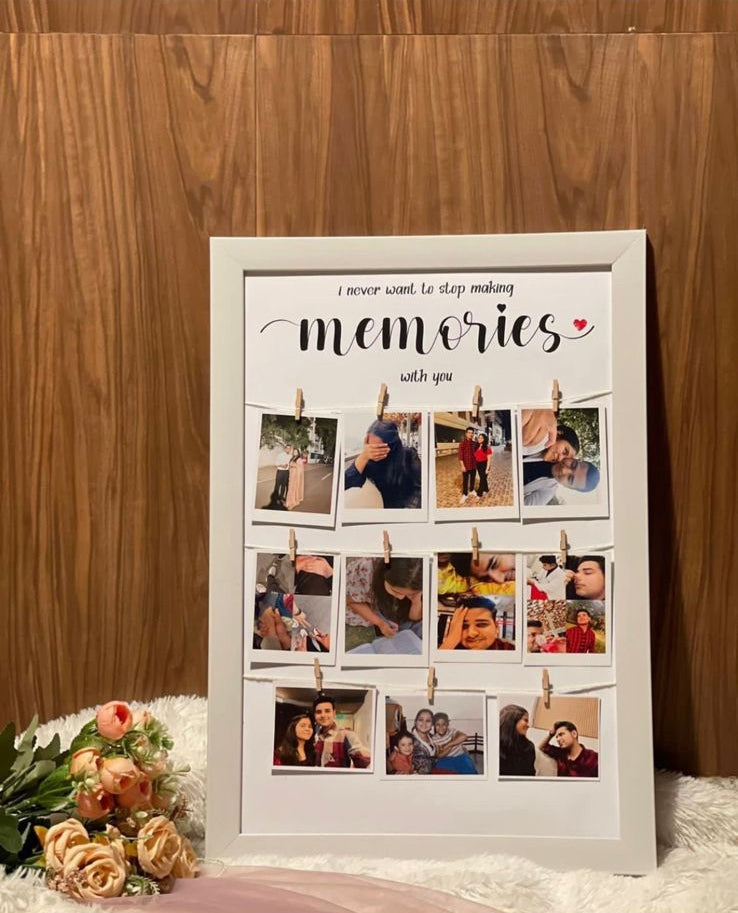 Handcrafted decorative frame with clips holding photos, placed against wooden background