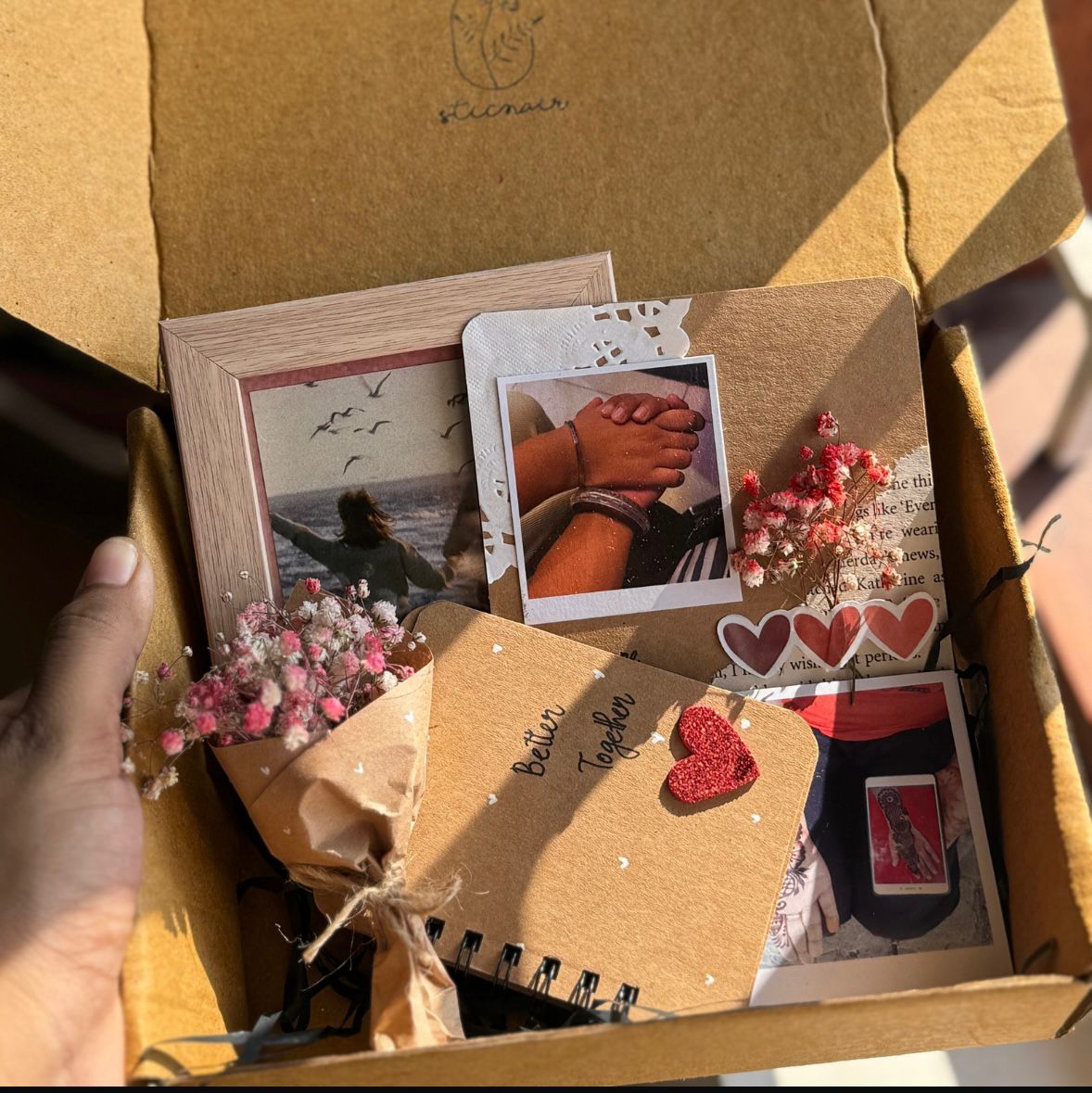 Personalized love hamper with photo album, polaroids and flower bouquet
