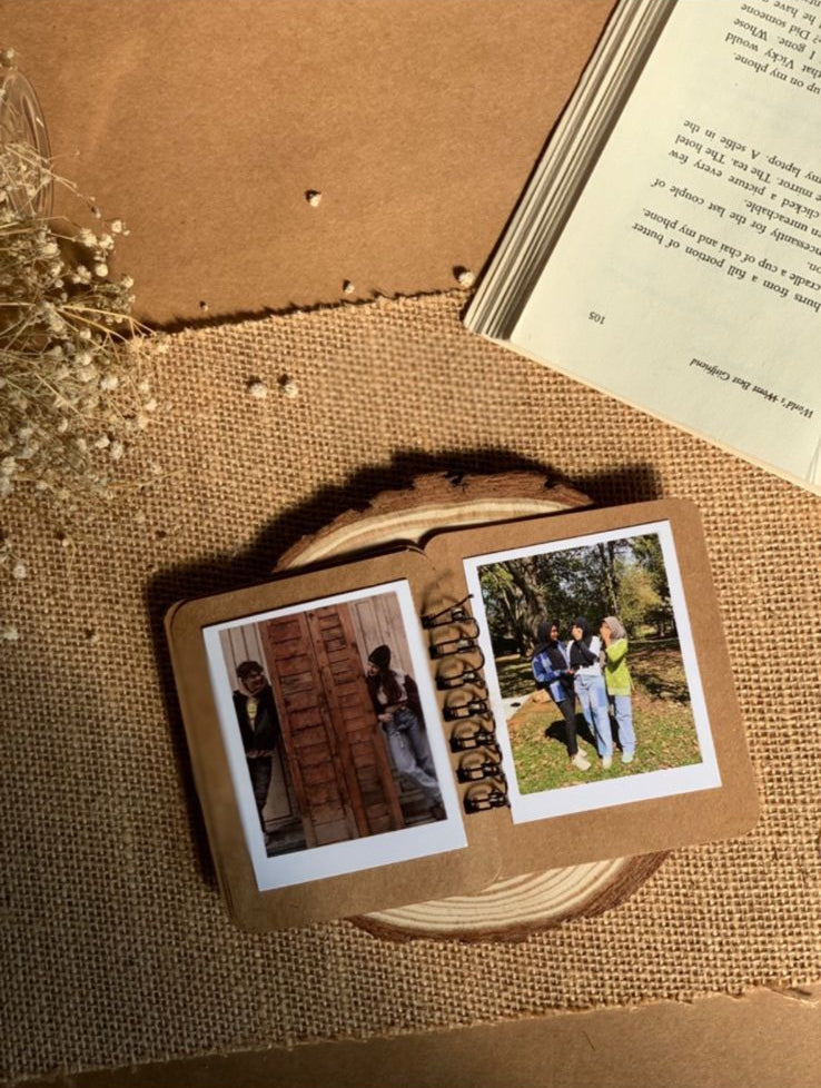 Handcrafted ring book with illustrated pages, personalized photo keepsake on textured surface