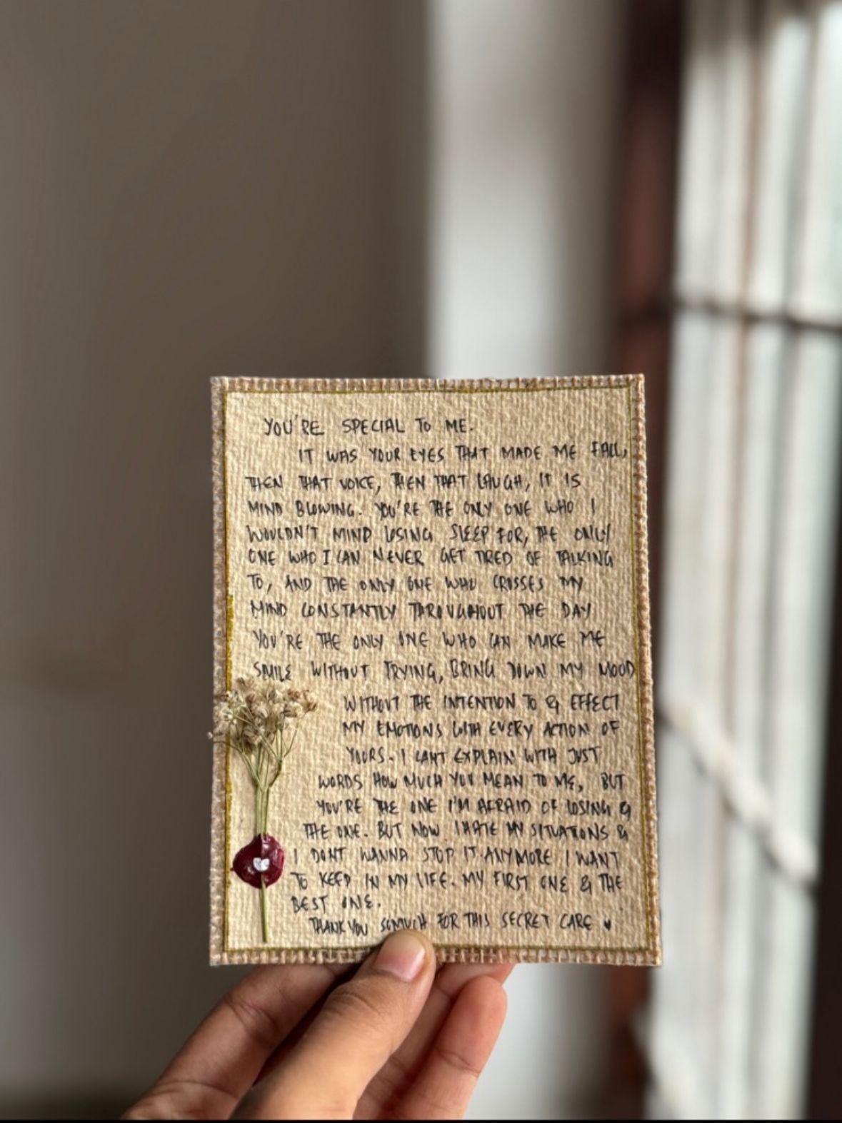 Handcrafted letter with wax seal held near window, elegant vintage greeting card gift